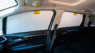 Car window covers for side windows as viewed from within a vehicle.