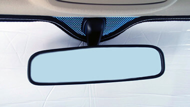 Heatshield windshield shades are secured using the rear view mirror for support